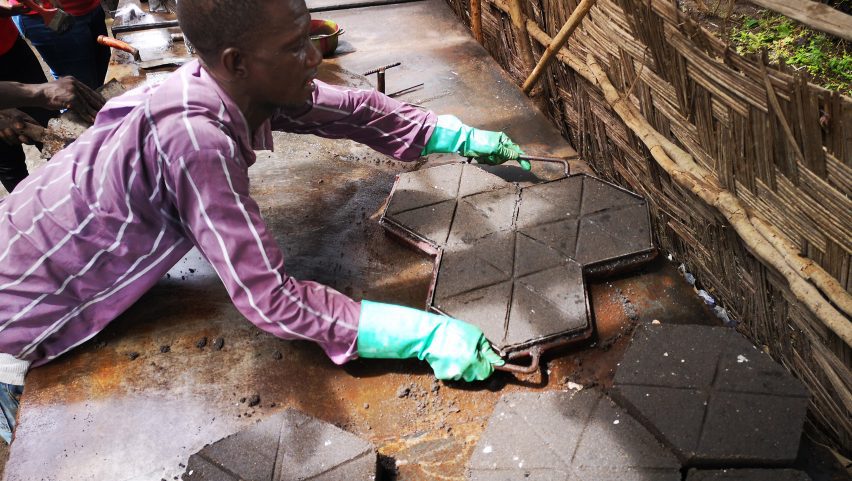 Man laying plastic bricks in Africa