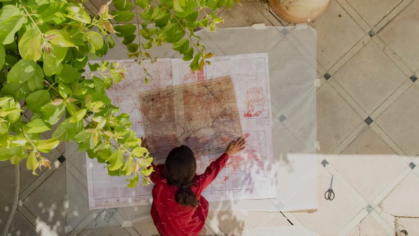 Woman looking over maps of Karachi