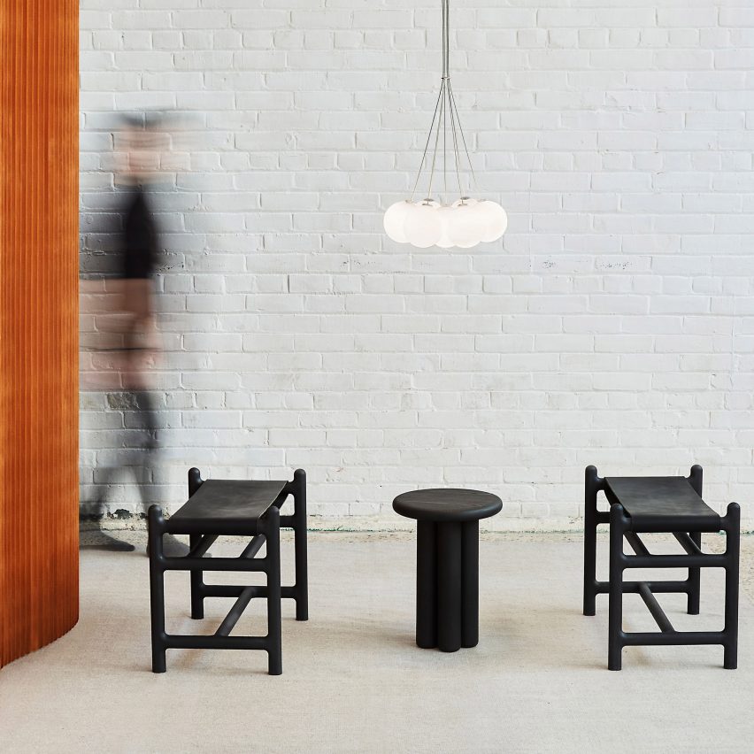 Black table and stools by Anony