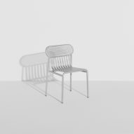 Shiny metallic chair in white room