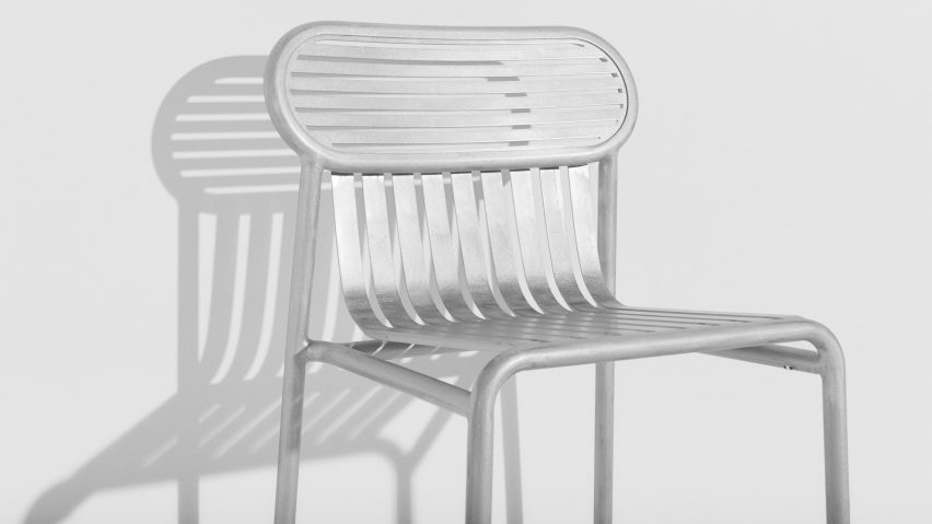Detail of shiny metallic chair in white room
