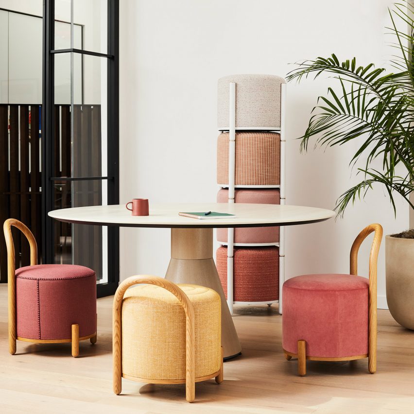 Pastel-coloured chairs and stools around round table