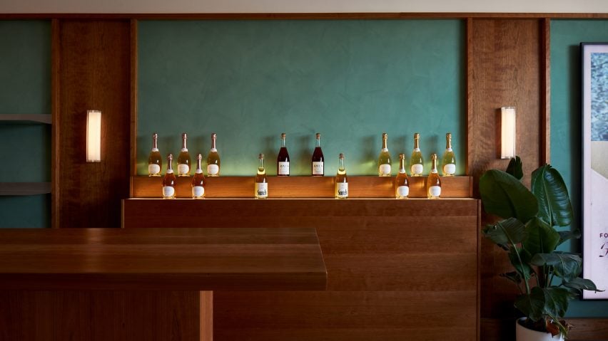 Bottles displayed on walnut-coloured wooden shelves