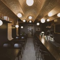 Studio North adds plywood barrel vaults to Business & Pleasure bar in Calgary