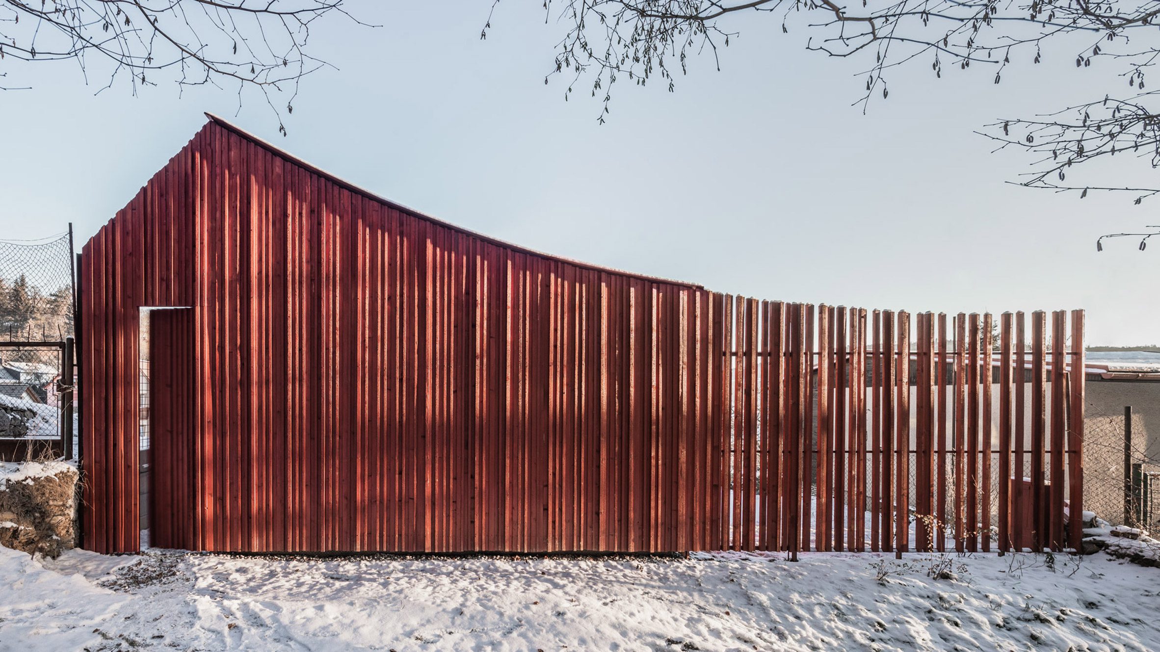 Byró Architekti adds red cabin with sweeping roof to Czech mountainside - Vimarsana News