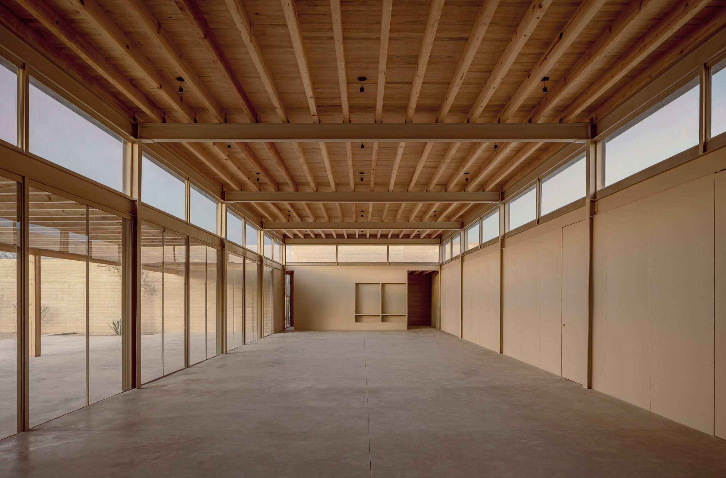 Wooden beams at sports complex by Taller Héctor Barroso