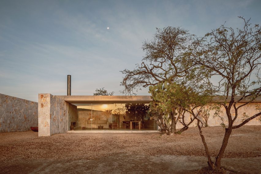 Endemic garden at rectilinear single-story stone house in Mexico by HW Studio