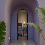 Purple arched entryway leading to a bedroom