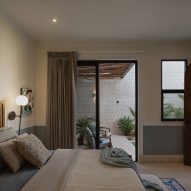 Interior of a bedroom with mosaic floor tiles at Casa Pulpo by Workshop Architects