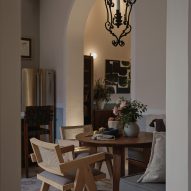 Interior dining space with wooden furniture and mosaic floor tiles