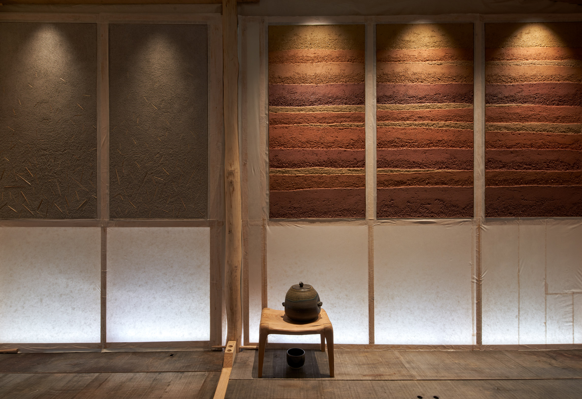 Teahouse interior with frosted glass and rammed earth screens