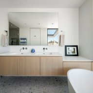Bathroom with white walls and wood vanity units
