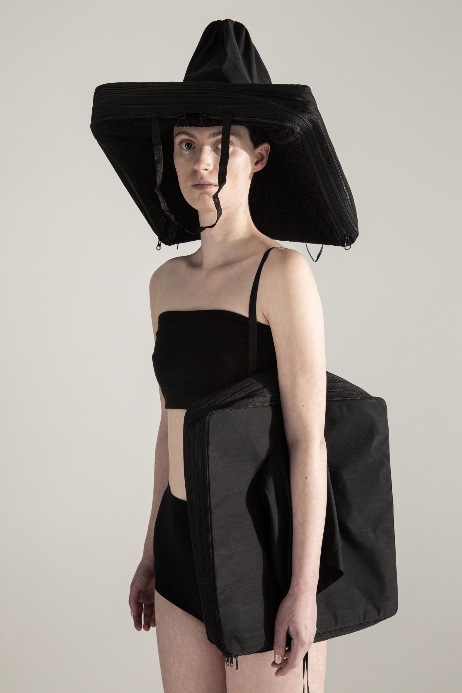 Black hat with zipped elements and a black matching outfit