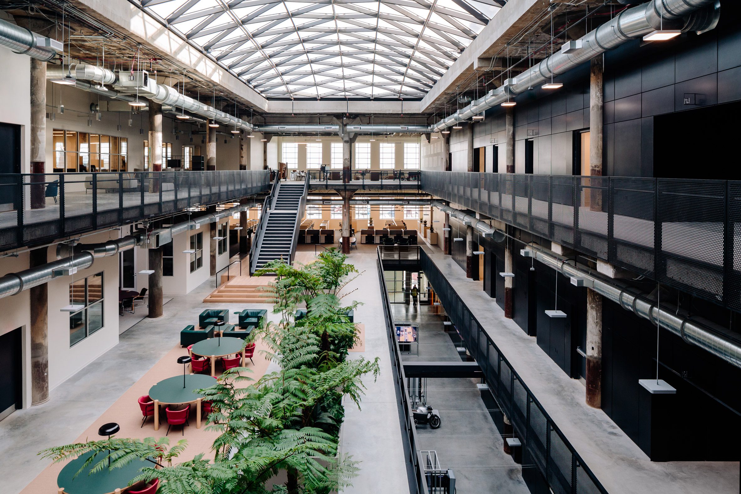 Interior atrium space with large skylight and open-plan co-working space