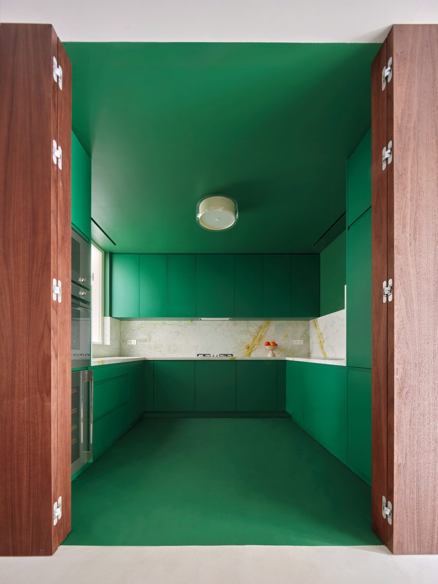 Green kitchen interior of Girona Street apartment in Barcelona, designed by Raúl Sanchez Architects