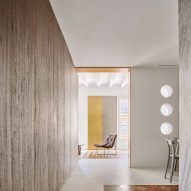 Girona Street apartment designed by Raúl Sanchez Architects features walnut wood wall