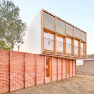 Agora Arquitectura elevates prefabricated timber home on brick base