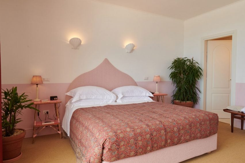 Bedroom with pink wainscoting and large bed