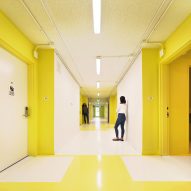 Yellow and white internal corridor at The Alvarado by Kadre Architects
