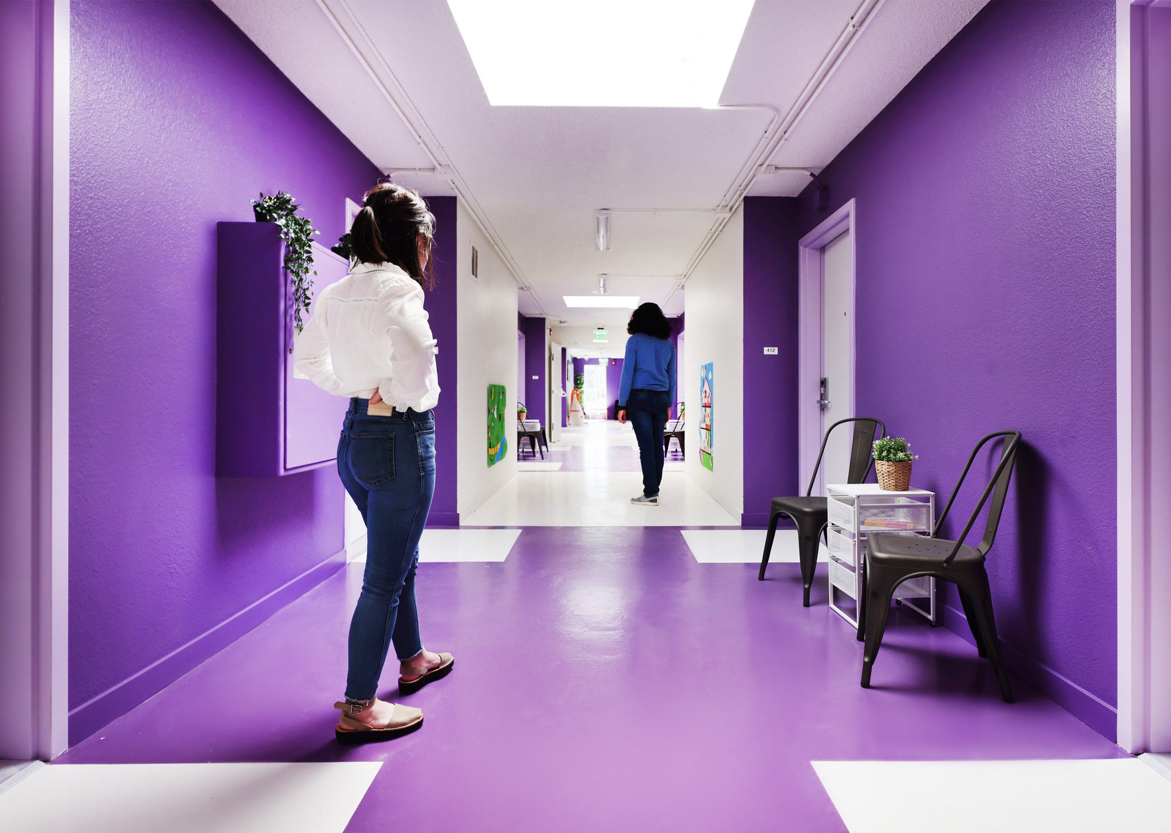 Interior corridor with purple and white glossy walls