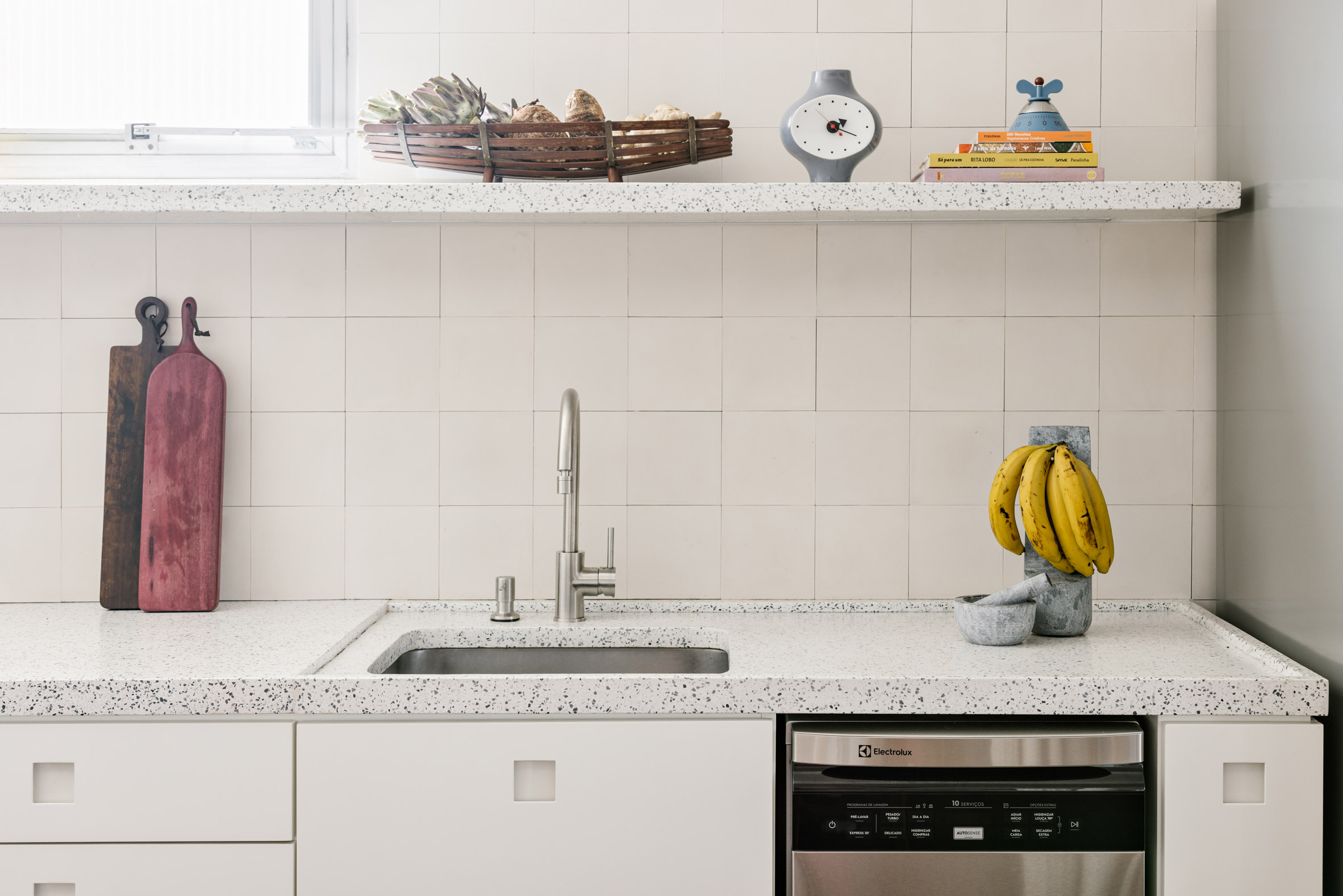 White kitchen with terrazzo countertops and hydraulic tiles