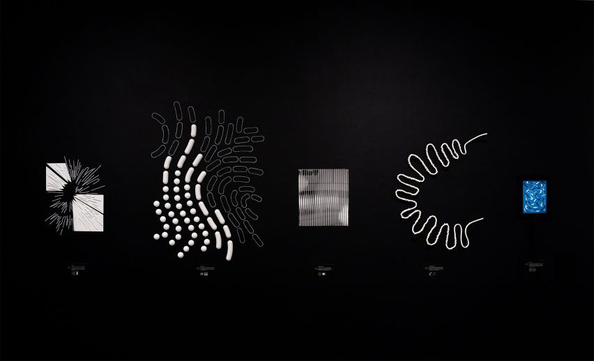 Gallery with dark exhibition with abstract shapes