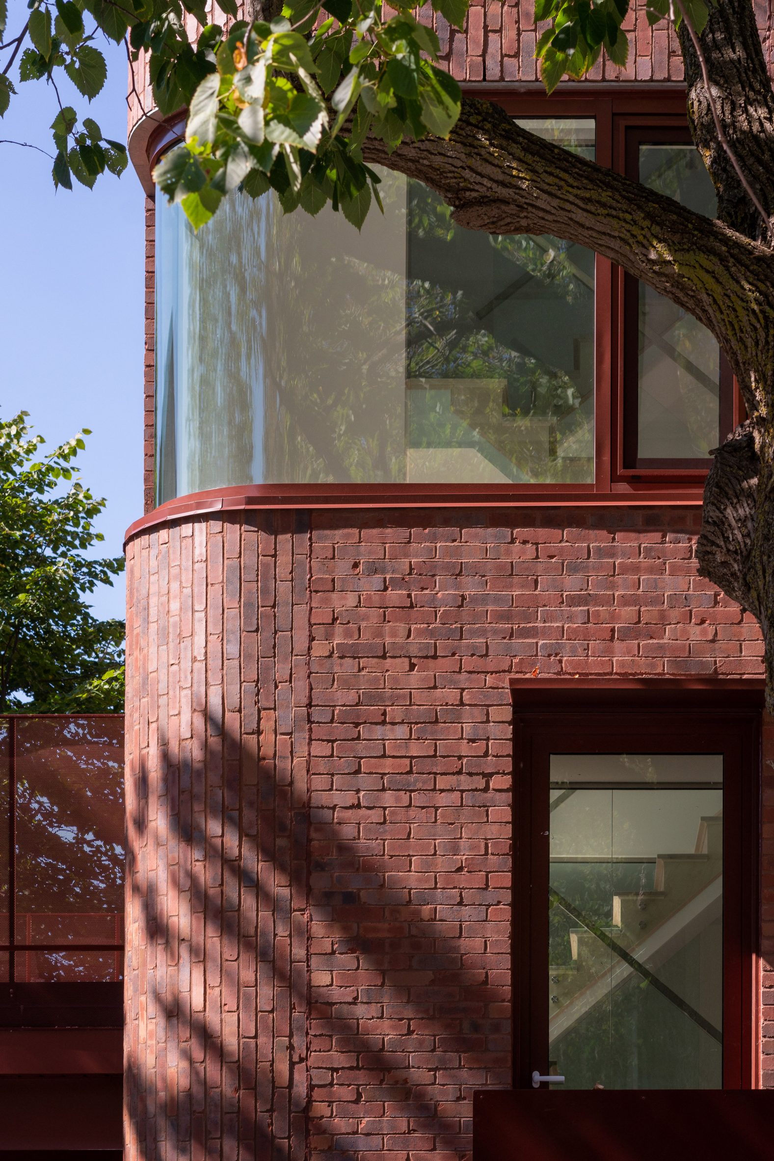 Red brick and curved glass windows on housing block