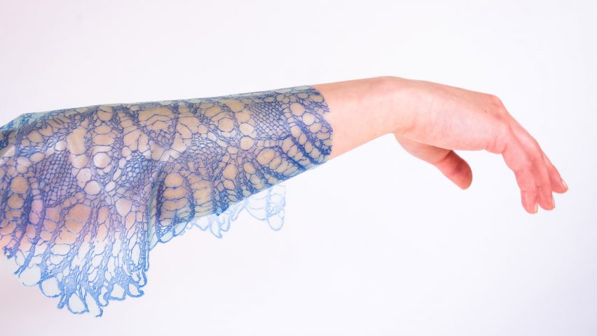 Arm draped in blue lacey fabric