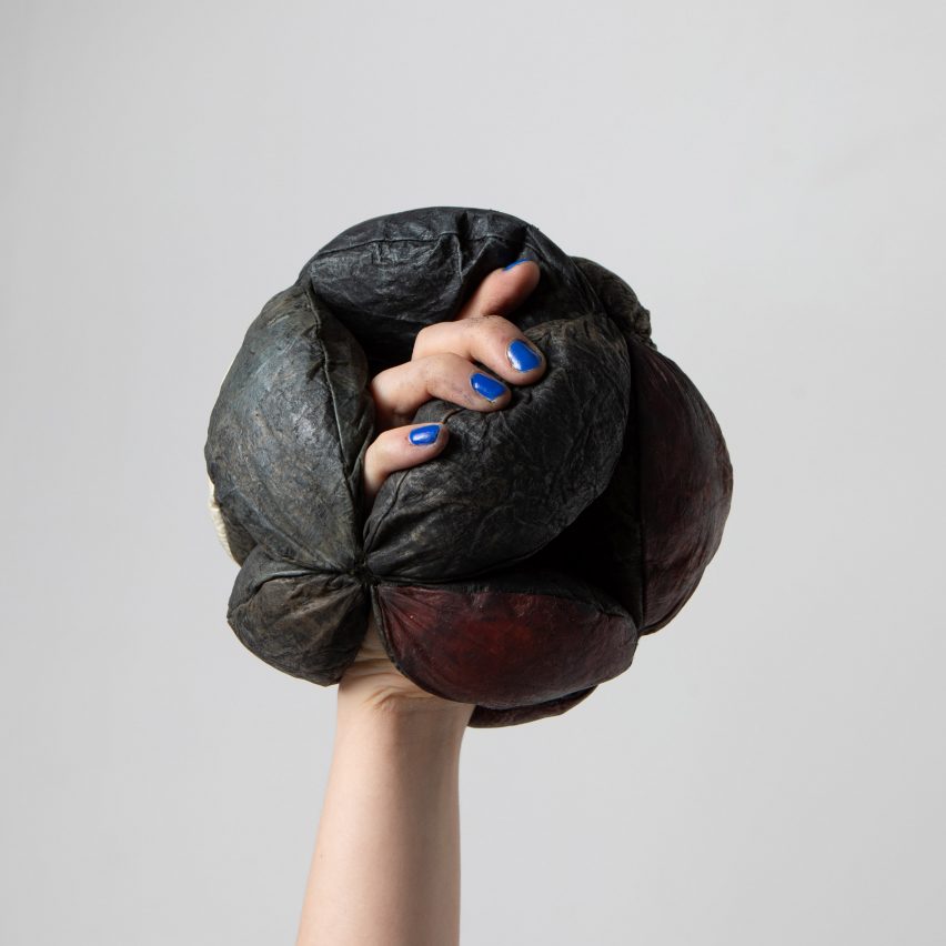 Hand and forearm with hand encased in fabric sphere