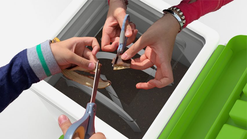 Hands using scissors to chop up fruit skins