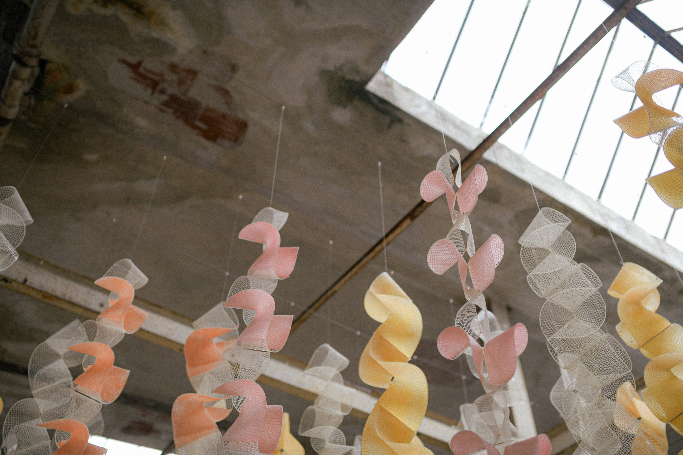 Photo of the tops of the ribbons making up the hanging Sensbiom 2 installation, where they attach to the ceiling