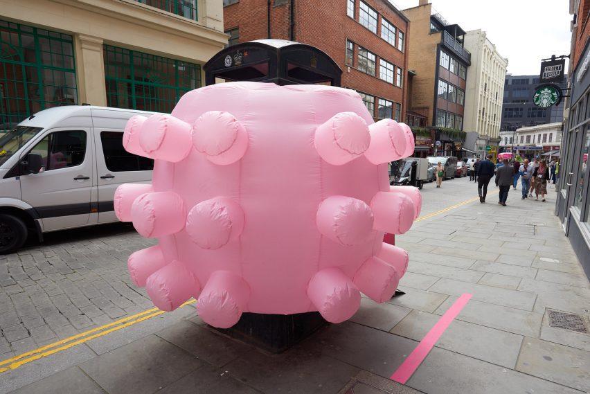 Pink inflatable sculpture with bulbous protrusions