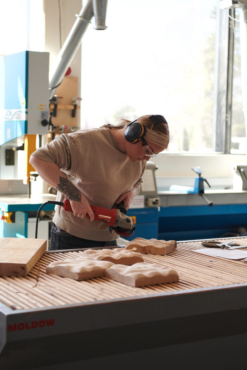 Designer working on wood pieces for Three exhibition