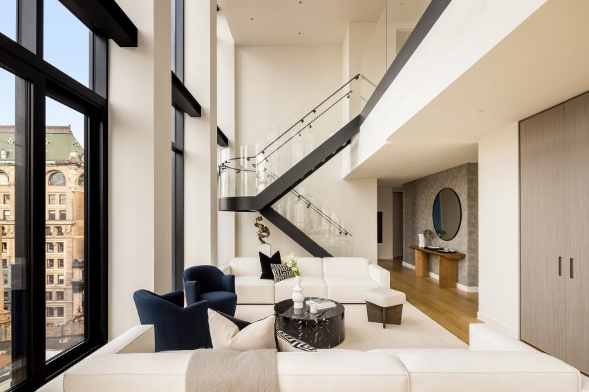 Staircase with glass balustrades connects to mezzanine level