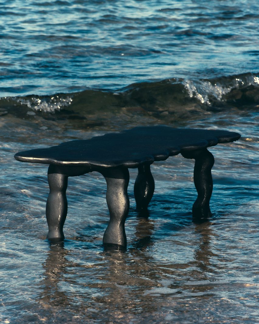 Photo of a black aluminium table by Ferm Living and Anna Maria Øfstedal Eng in water