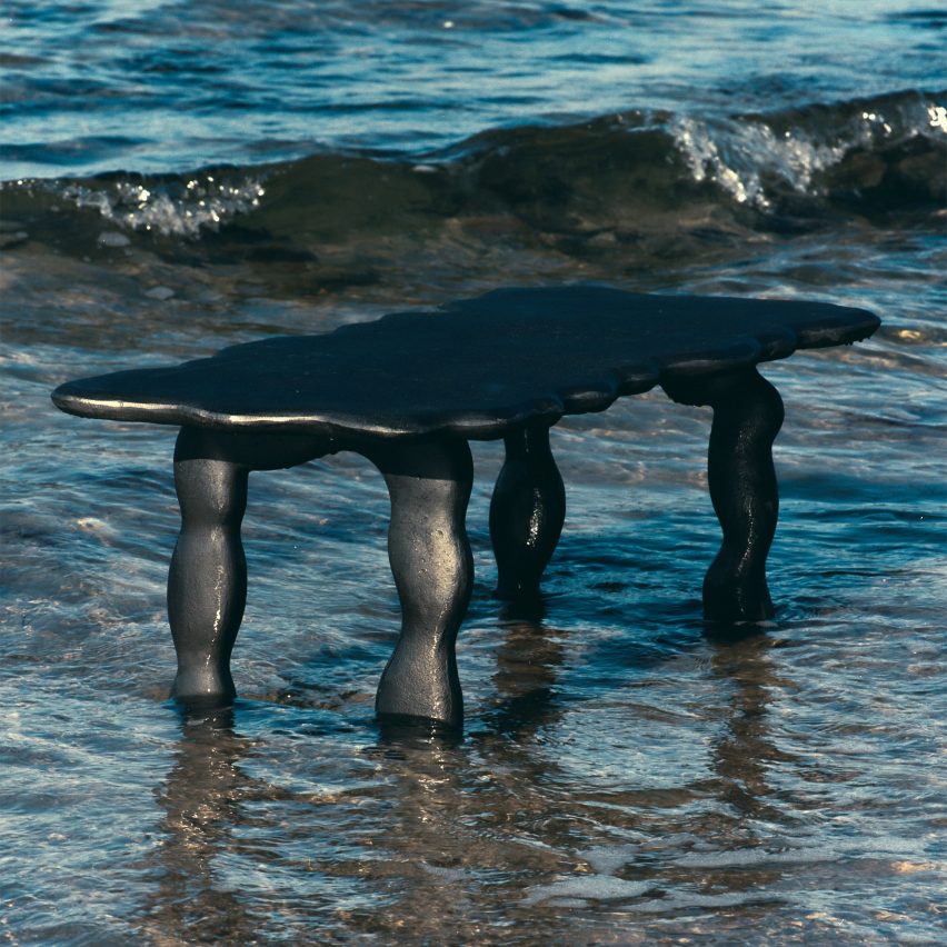 Photo of a black aluminium table by Ferm Living and Anna Maria Øfstedal Eng in water