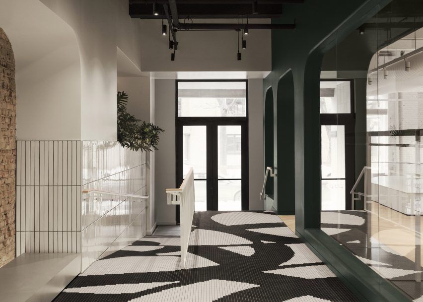 Entryway with black and white mosaic flooring
