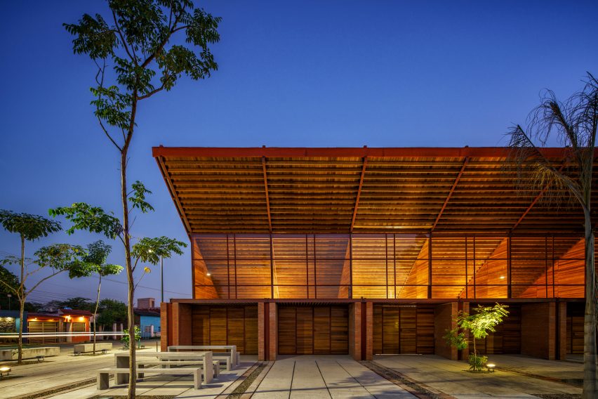Exterior of the brick Casa de Musica school by Colectivo C733 with large windows and a cantilevered timber roof