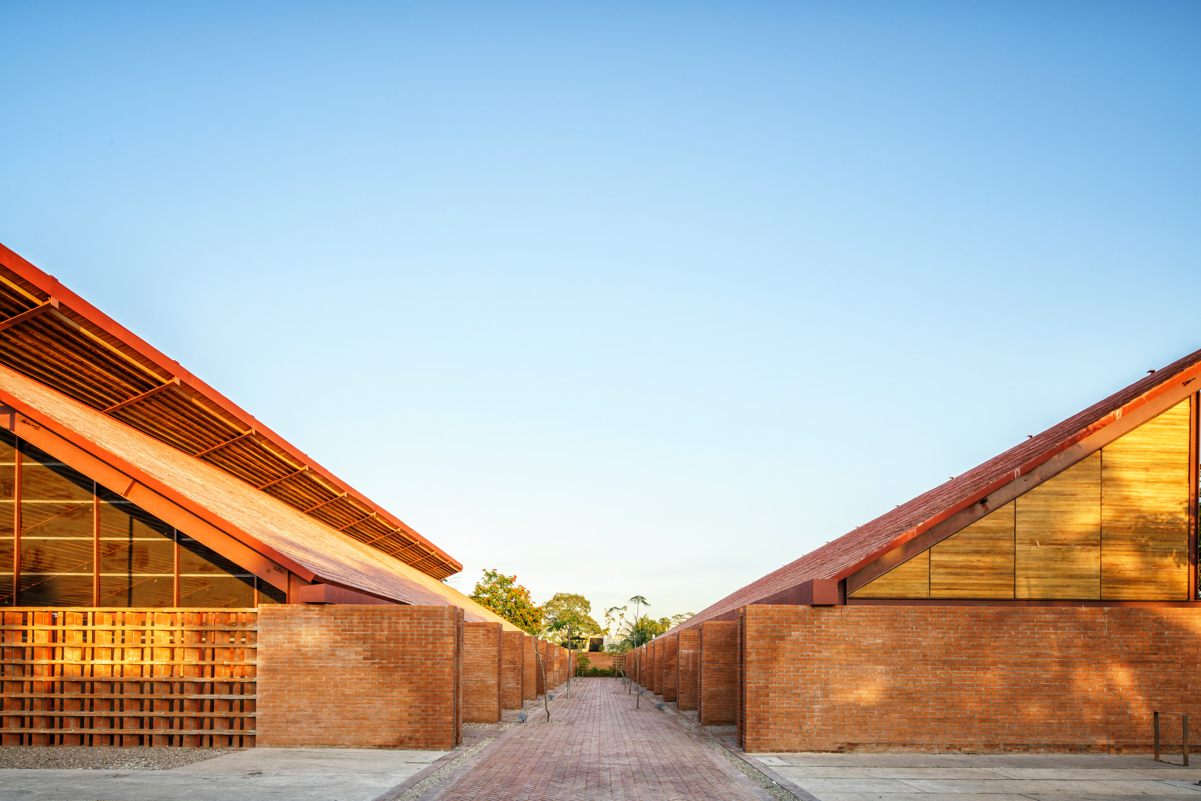 Two external brick walls topped with pitched timber roofs