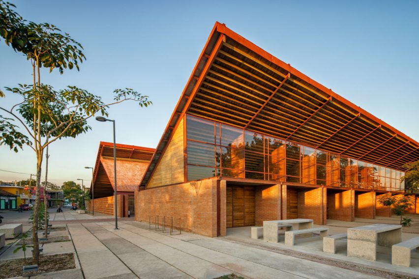 Exterior of the brick Casa de Musica school by Colectivo C733 with cantilevered timber roofs
