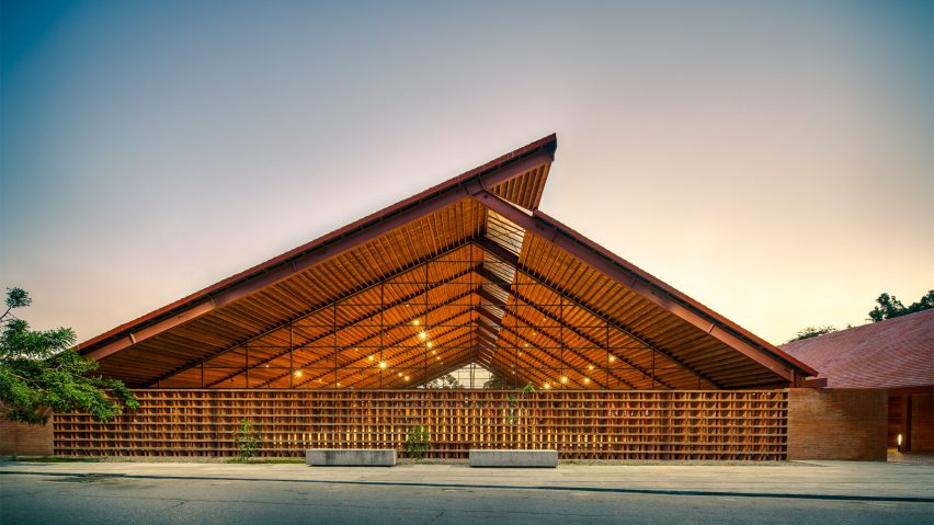 Exterior of the brick Casa de Musica school by Colectivo C733 with a cantilevered timber roof