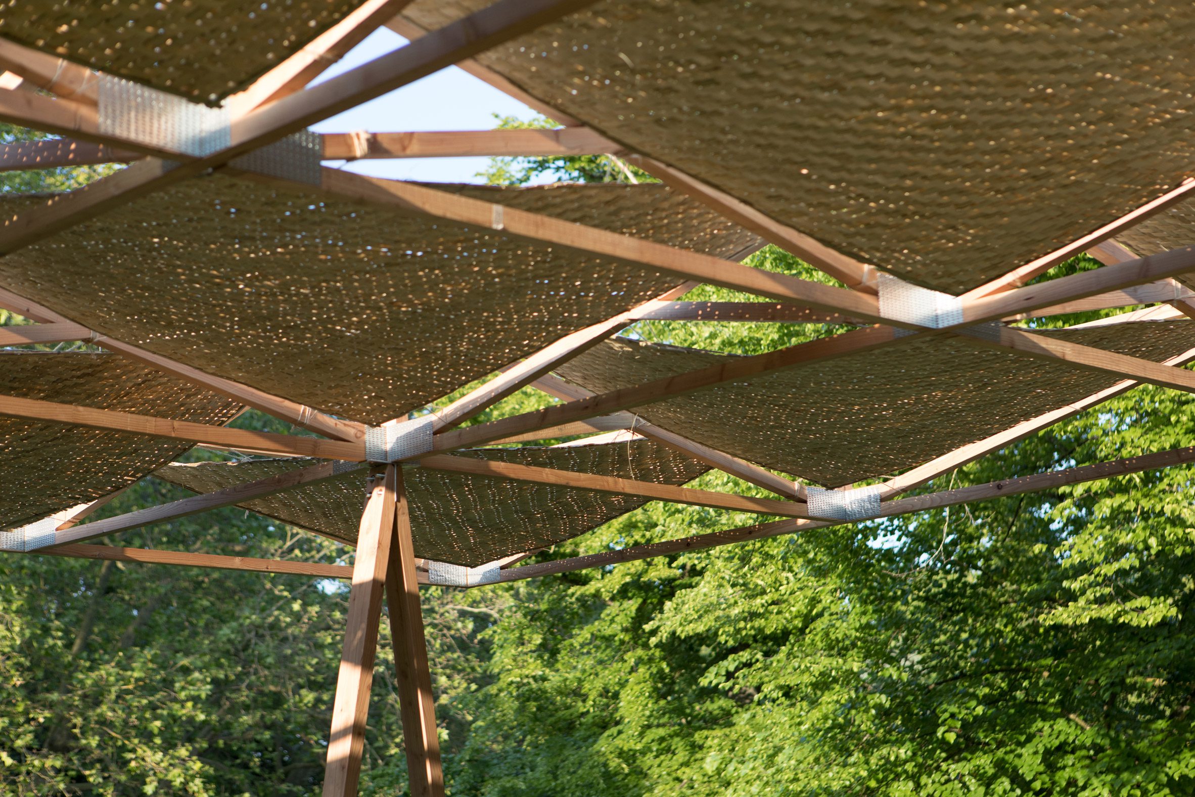 Underside of a timber structure roof with woven bamboo inserts