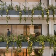 Plant-filled balconies at and apartment building with glass sliding doors