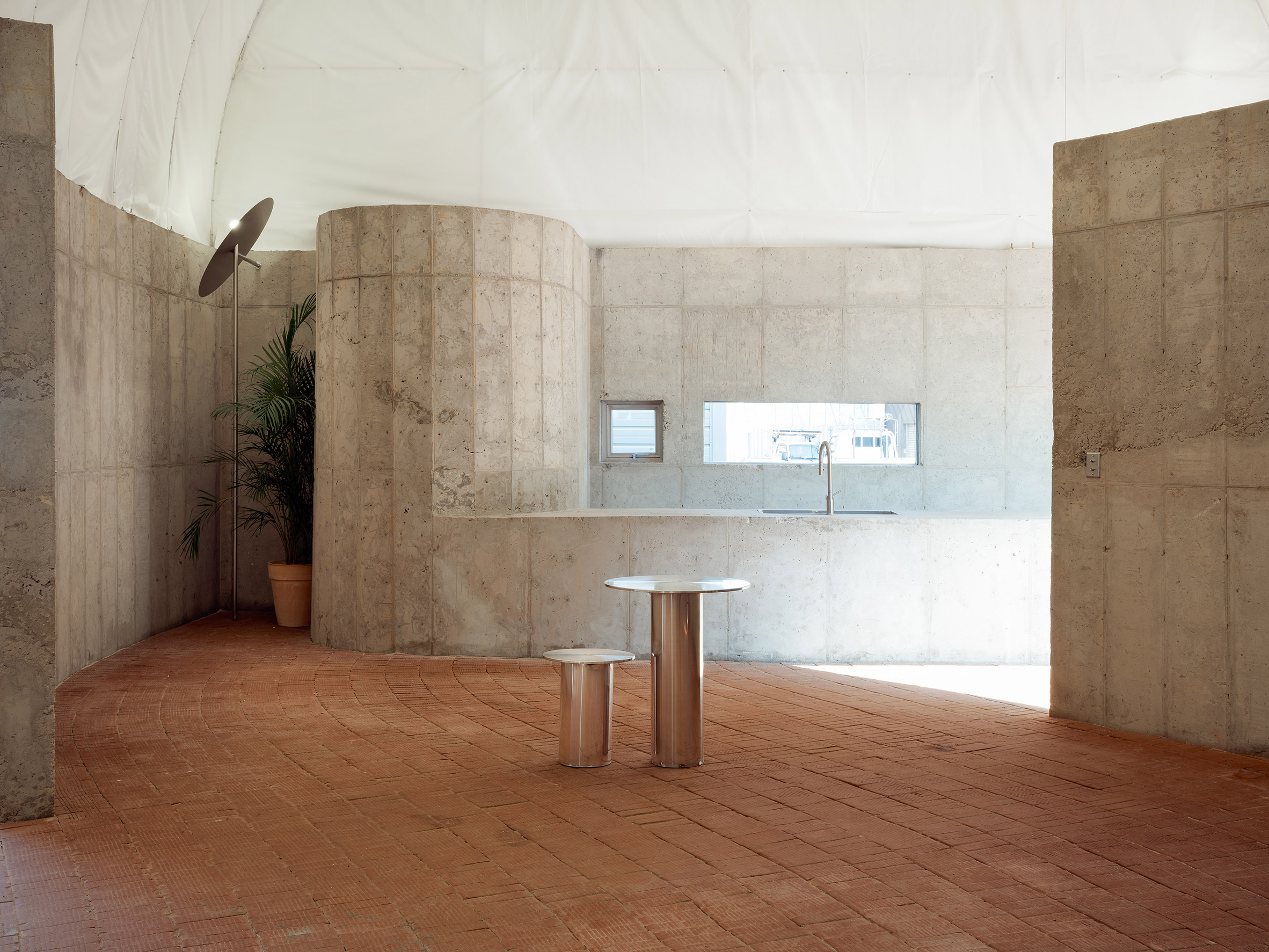 Concrete office space with brick floor