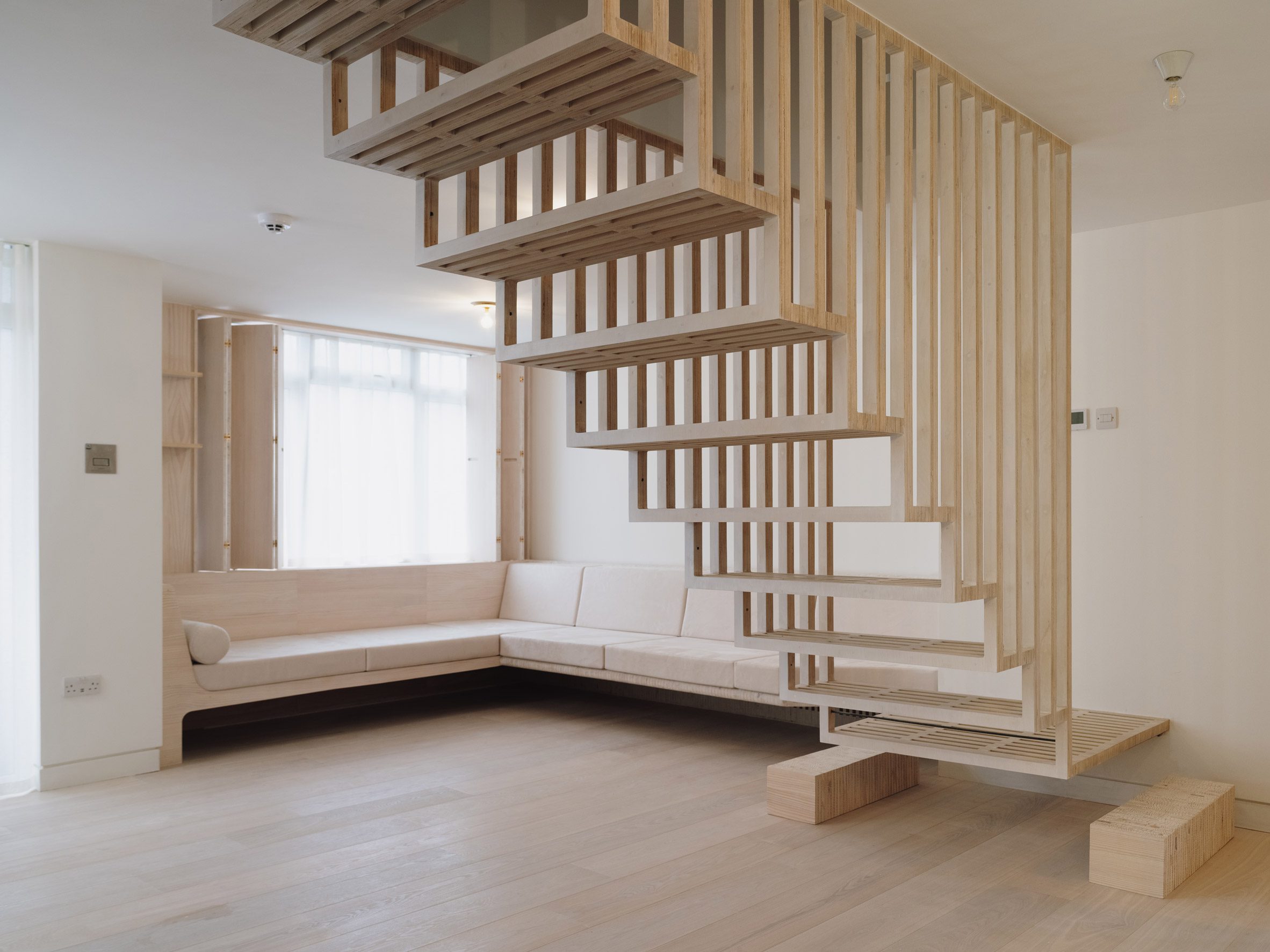 Staircase and living space in Dragon Flat by Tsuruta Architects