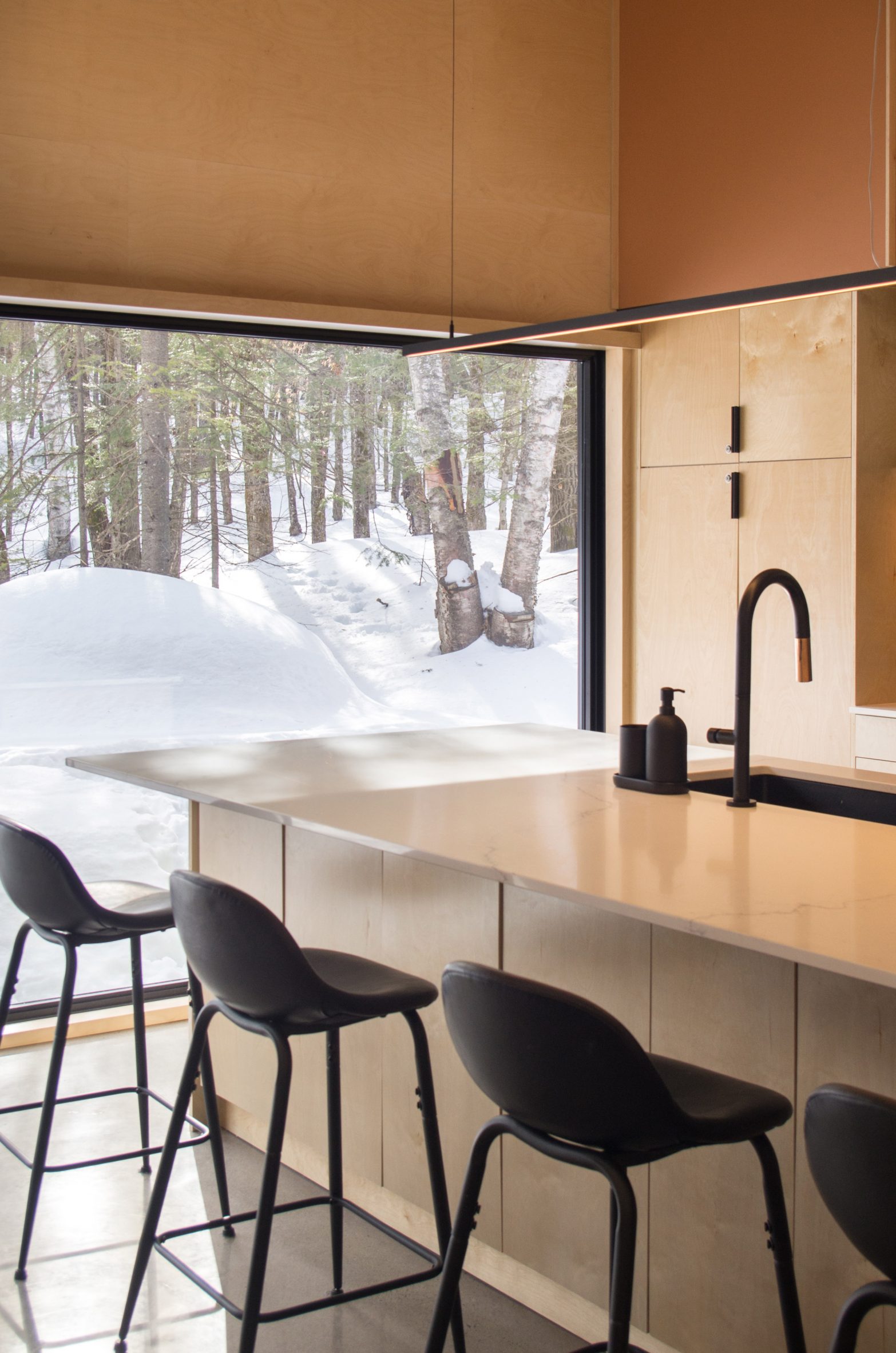 Glass windows with views of snow in the kitchen