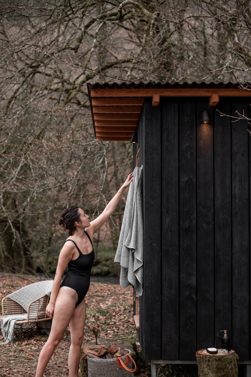 Woman outside Forest Sauna in Devon by Out of the Valley