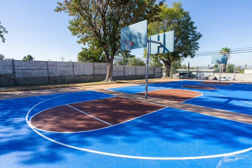 Basketball court with solar-reflective coating in blue and tan