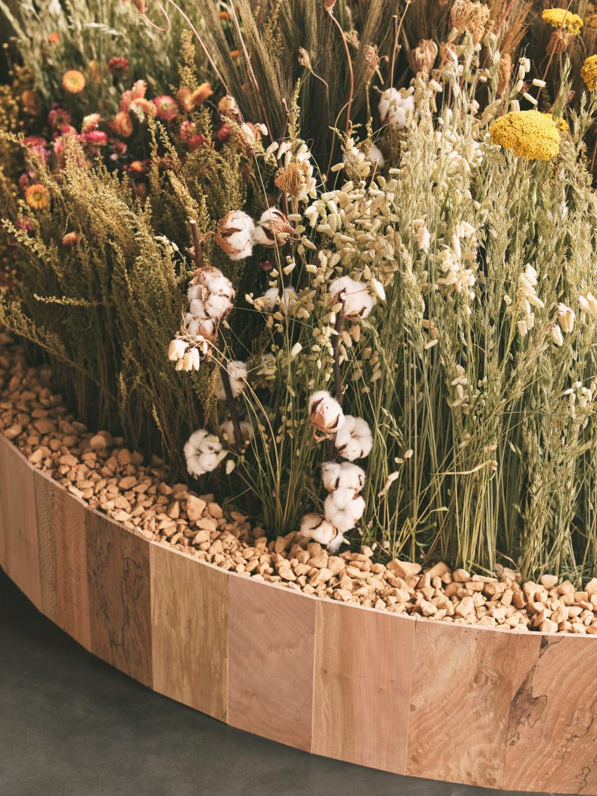 Dried flowers and grasses in a bed of stones inside Lestrange store in Coal's Drop Yard 