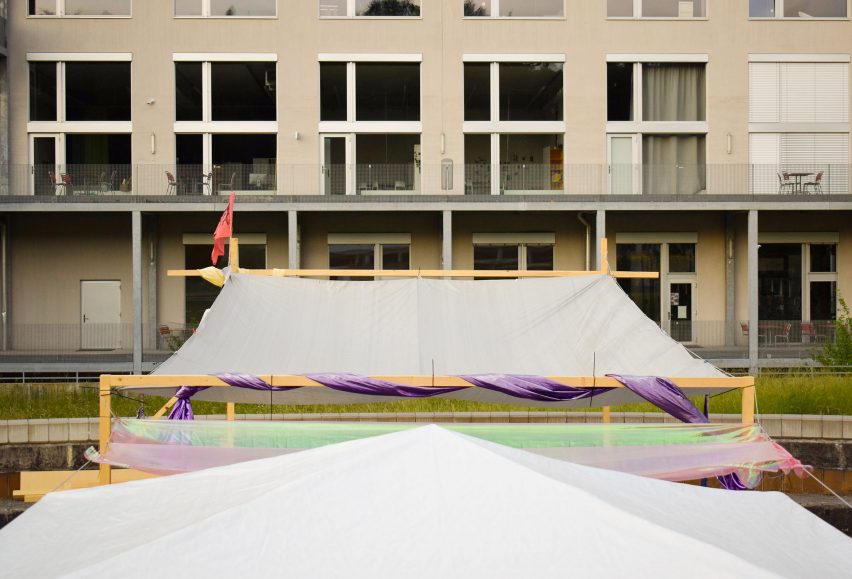 Photograph showing tent-like covering attached to building facade